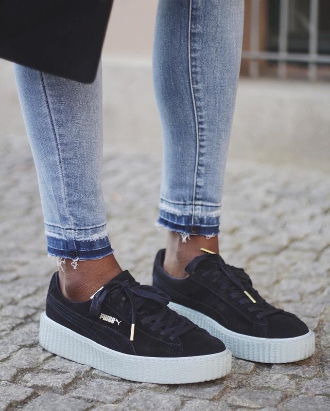 Puma Suede Classic Black on feet with Jeans